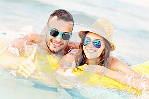 Young couple swimming on a matress photo