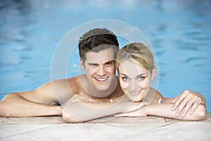 Young Couple Swimming In Pool