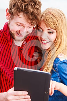 Young couple with tablet outdoor