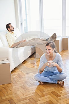 Young couple taking a break from unpacking