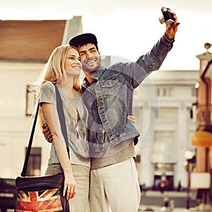 Young couple taking self portrait photo at old camera