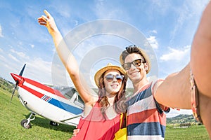 Young couple taking selfie with lightweight airplane