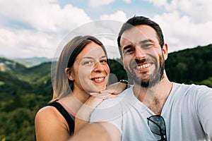 Young couple taking a selfie in the mountains