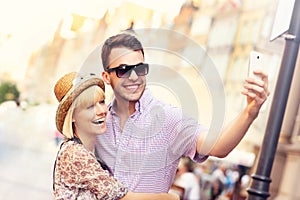 Young couple taking selfie while sightseeing the city