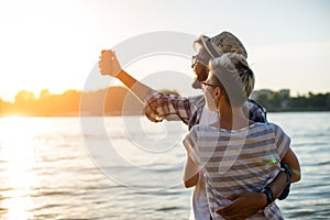 Young couple taking selfie in sunset