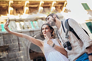 Young couple taking a selfportrait with smartphone.