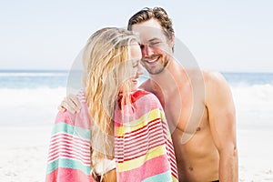 Young couple talking to each other on the beach