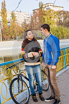 Young Couple Talking on Urban Park Bridge