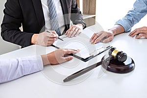 Young couple telling their problems in the courthouse to getting divorced or premarital agreement in lawyers office, deciding on