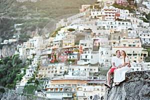 Young couple tenderly together in honeymoon in Positano, Amalfi coast, Italy