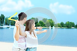 Young couple throwing boomerang. Summer outdoor activities