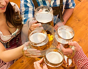 Young couple toasting in Oktoberfest beer tent