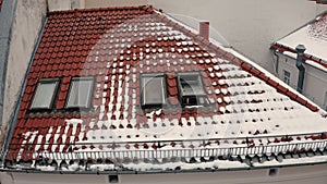 Young couple together, man and woman open windows synchronously on roof, smile, kiss, wave hands.