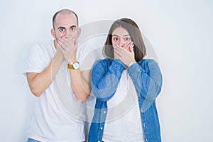 Young couple together over white isolated background shocked covering mouth with hands for mistake