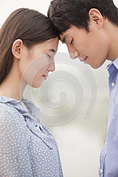 Young Couple Touching Foreheads