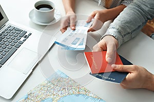 Young couple in a tour agency travelling concept holding passports and tickets