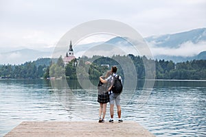 Young couple of tourists in love on the Lake Bled, Slovenia.