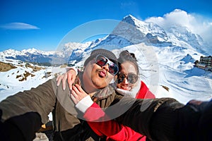 Young Couple Tourists selfie with mobile phone near Kleine Scheidegg station, along the railway from Interlaken to Jungfraujoch 3