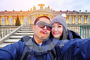 Young Couple Tourists selfie with smartphone at Sans Souci palace in Potsdam, Berlin, Germany