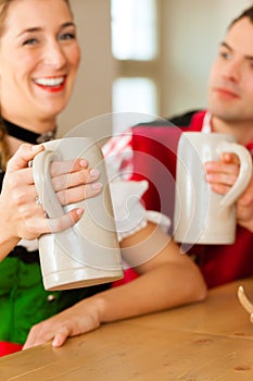 Young couple in traditional Bavarian Tracht in restaurant or pub