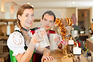 Young couple in traditional Bavarian Tracht in restaurant or pub