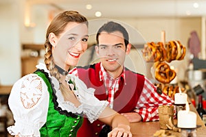 Young couple in traditional Bavarian Tracht in restaurant or pub