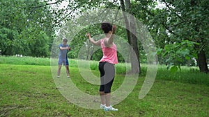 Young couple training together in the open air.