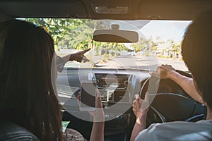 Young couple traveler using gps navigation in smartphone