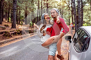 Young couple traveling by car in the forest