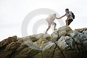 Young couple traveling together over the hill