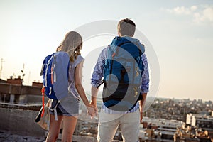 Young couple travelling with a map in the city