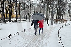 Young couple under the umbrella.