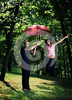 Young couple under umbrella.