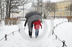 Young couple under the umbrella.