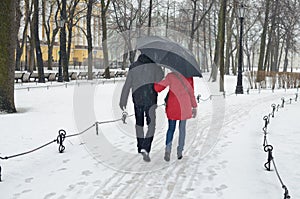 Young couple under the umbrella.