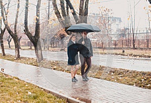 Young couple under an umbrella