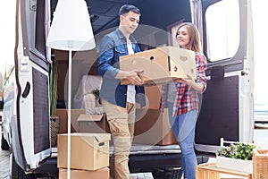 Young Couple Unloading Van