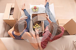 Young couple unpacking boxes