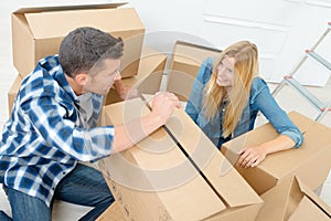 Young couple unpacking boxes