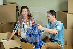 Young couple unpacking carton boxes