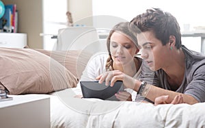 Young couple using digital tablet