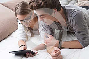 Young couple using digital tablet