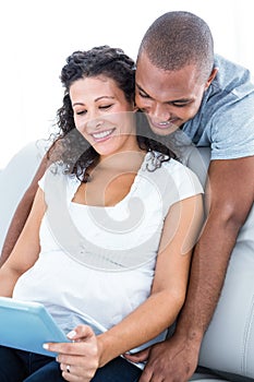 Young couple using digital tablet