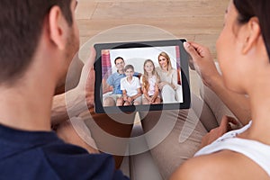 Young couple using digital tablet together