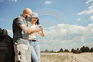 Young couple using gps navigator app for traveling