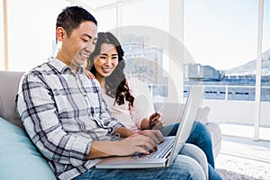 Young couple using laptop