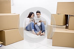 Young couple using a tablet in a new house