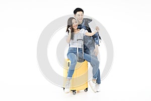 Young Couple using tablet.  Young Couple selfie happy and go on the travel in white background. Man and woman backpack