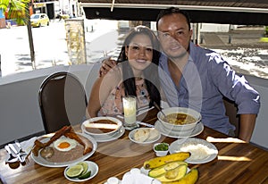 A young couple on vacation eating