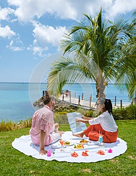 young couple on vacation Saint Lucia, luxury holiday Caribbean, picnic with map vacation concept